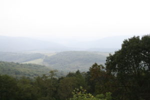 view looking down into a mountain valley, misty