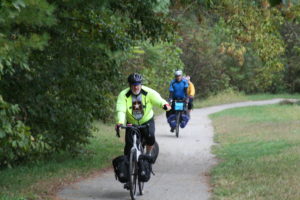 three bicyclists in rain gear