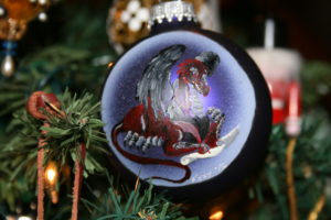 a painted glass ornament, a dragon, writing