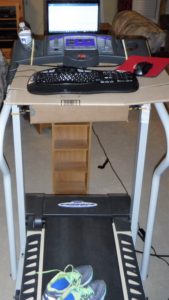 treadmill with boxes bungie corded to make a platform for keyboard. Computer on a DVD holder.