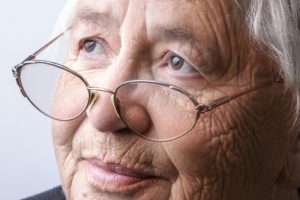 picture of an older woman, gray hair and glasses perched on her nose